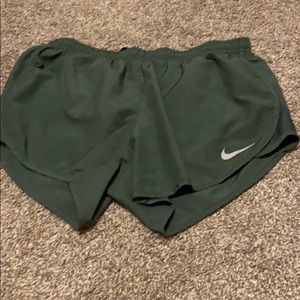 green n ike dry tempo running shorts with lining.